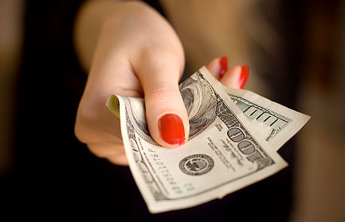 Woman Giving Money to Someone